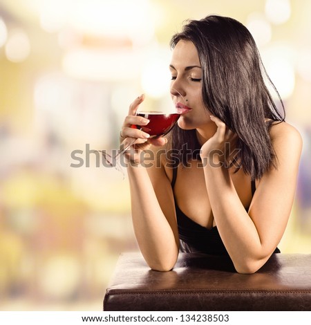 young beautiful woman in bar with red wine