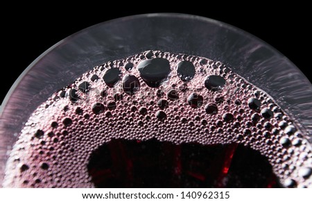 Red wine in wineglass on a black background,saved clipping path