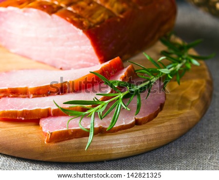 smoked meat and rosemary on a linen cloth