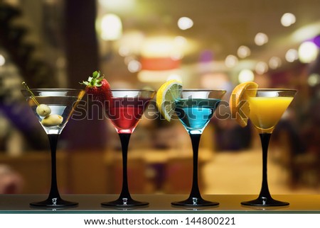 Different Cocktails Or Longdrinks Garnished With Fruits