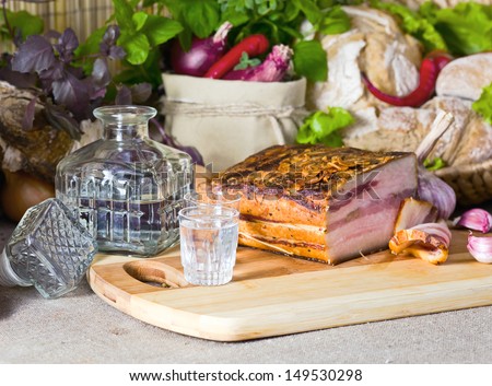 Vodka and smoked meat on a table