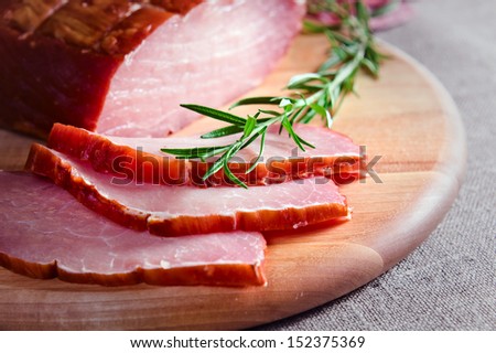 smoked meat and rosemary on a kitchen table