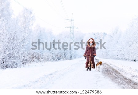 The woman in fur coat walk with dog