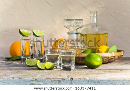 tequila and citrus fruits on a old table
