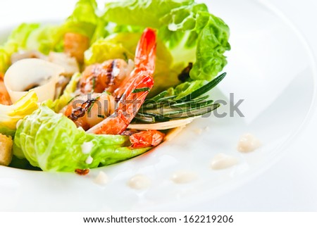 Caesar salad with cheese, prawns and greens