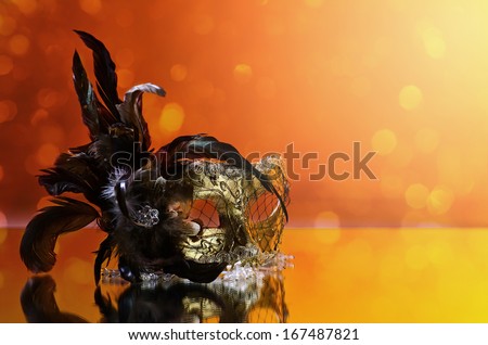 The Venetian mask with feather on  mirror table