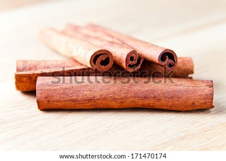 cinnamon sticks on wooden table , focus on foreground