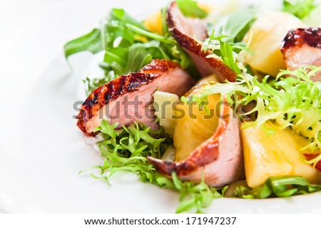 salad with greens, pineapple and smoked meat