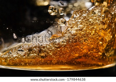 detail of an alcoholic beverage on black background