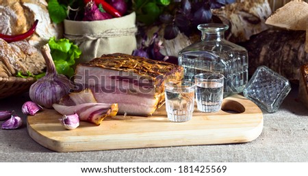 Vodka and smoked meat on a kichen table