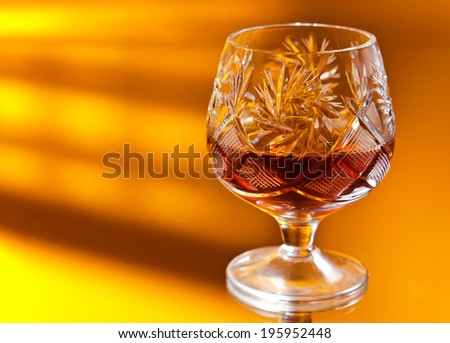 shot of a cut crystal glass on mirror table