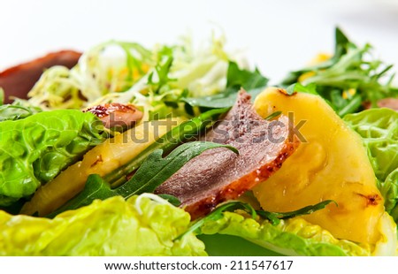 salad with greens, pineapple and smoked meat