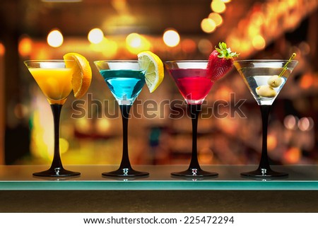 Different cocktails or longdrinks garnished with fruits