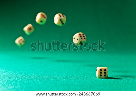 dice  on a green table in casino , focus on foreground