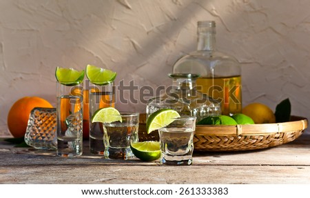 tequila and citrus fruits on a old table