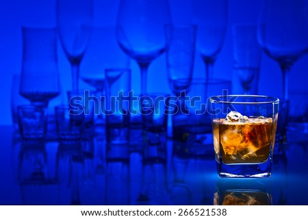 whiskey with natural ice on glass table in bar