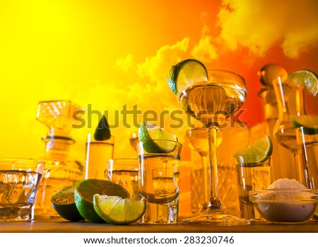 gold tequila , lime and salt , focus on foreground