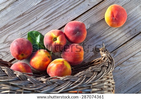 juicy peaches on wooden table in garden