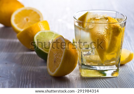 gin with tonic , lemon and ice on  old wooden table