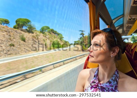 The woman in the bus looks out of the window