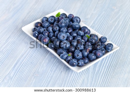 blueberry, ripe berries on blue kitchen table