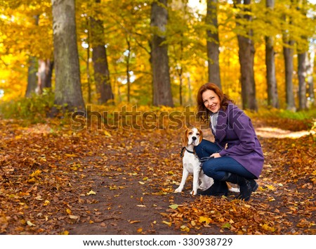woman with dog walking in the park