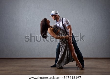 The young couple dancing in empty room