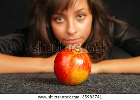 beautiful girl in black with ripe apple,focus on a apple