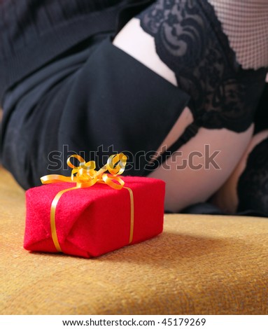 woman in black stockings with gift,focus on a box.