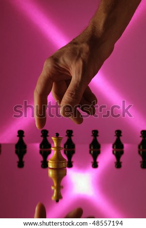 chess on a mirror table and hand