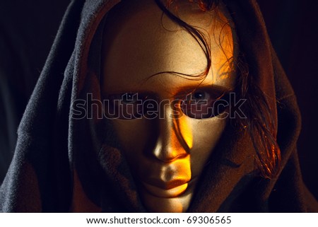 The person in a gold mask.
