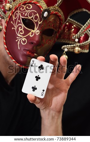 The person in a mask with cards.