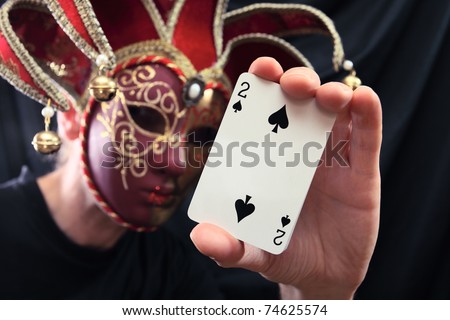 The person in a mask with cards.