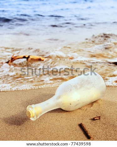 Message in a bottle on a sea beach