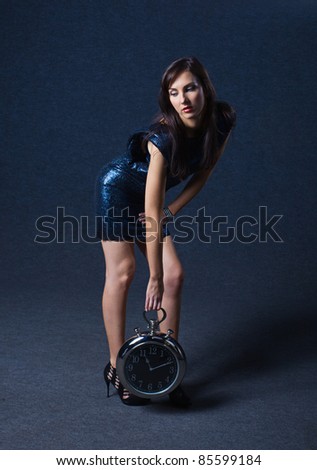 young woman with clock, professional make-up.