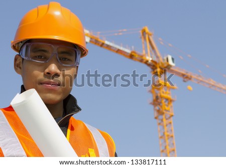 Close up site manager with safety vest under construction