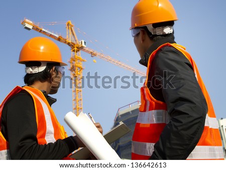 Two engineer construction. Site manager with safety vest discussion under construction