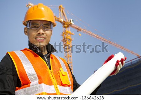 Portrait site manager with safety vest under construction