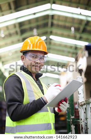 Portrait asian engineer with checklist look on you camera vertical image