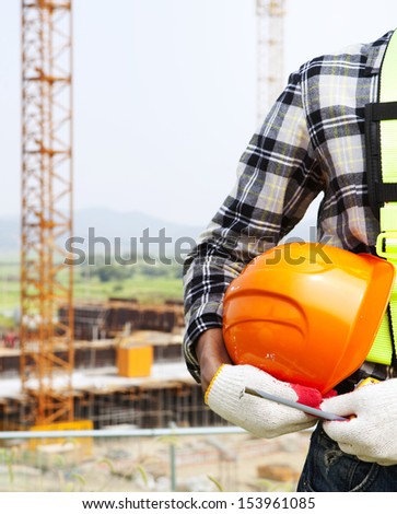 Vertical image construction safety concept, Close-up construction worker holding helmet