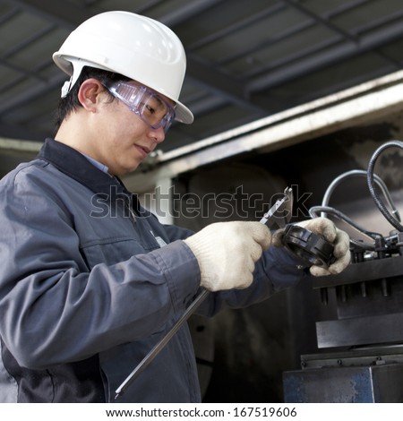 mechanical technician measuring detail after steel