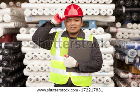 Textile factory labor standing  in warehouse fabrics