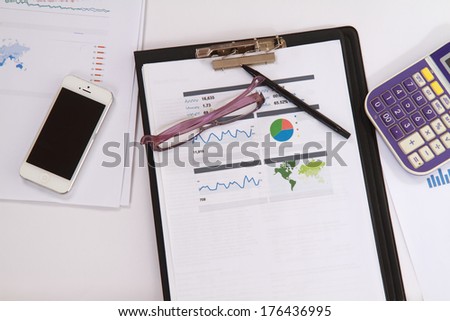 Close-up shot of office objects and statistical documents.