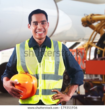 Portrait of asian professional engineer holding safety helmet at work