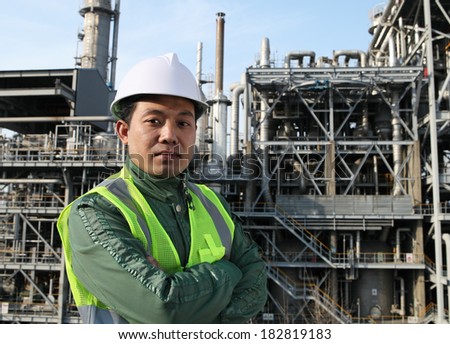 Chemical industrial  engineer wearing safety work standing front of large oil industry