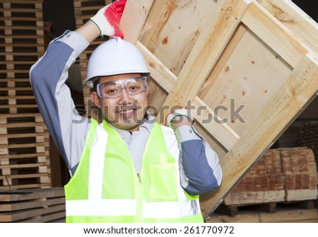 Carpenter lifting pallet in the warehouse