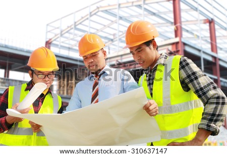 Architect and foreman construction worker discussion a plan, looking blueprint on location site