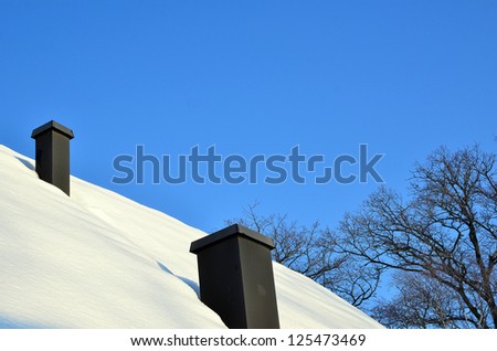 Ventilation hoods on roof with snow