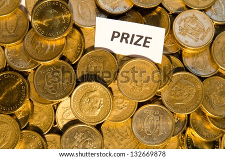 Stack of golden coins with a sign showing Prize