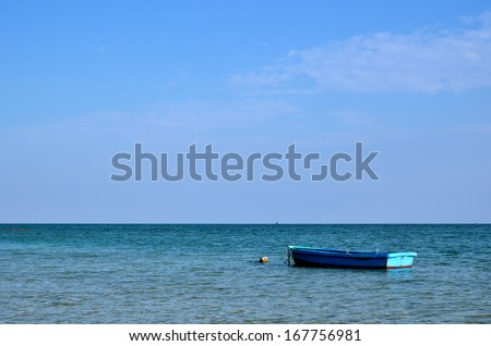 Blue boat at the western coast of the japanese island Okinawa